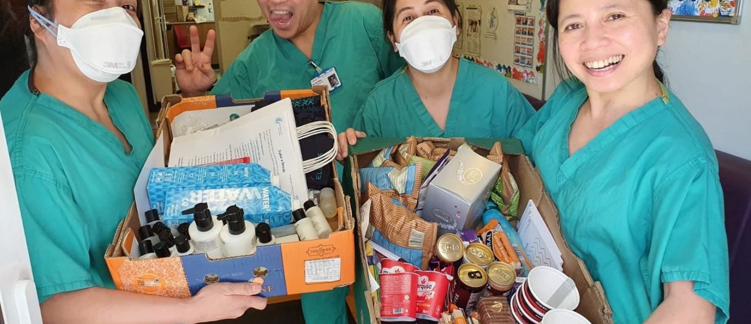 Staff with goodies from care packages.jpg